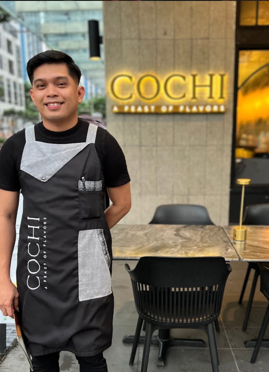 A COCHI team member standing outside the restaurant