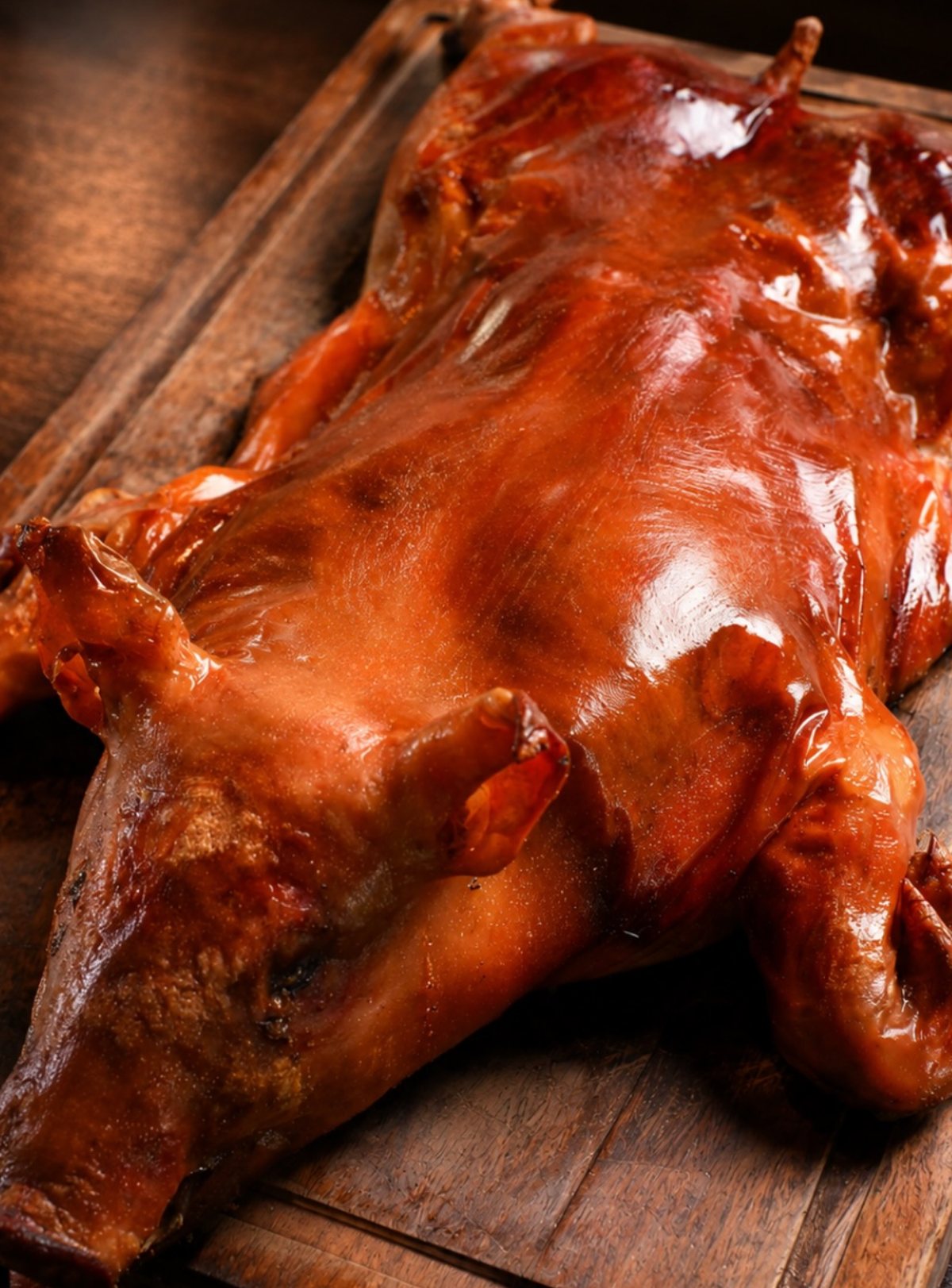 Whole roasted cochinillo on a wooden board