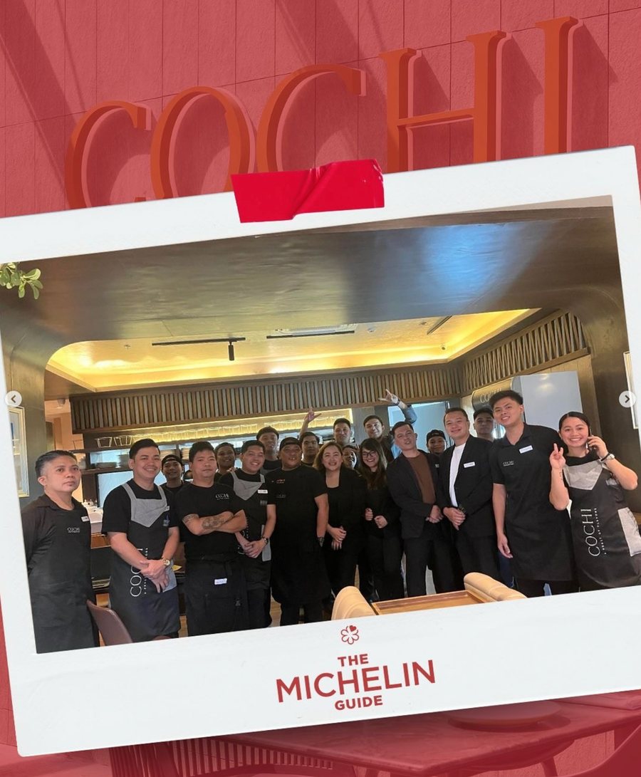 COCHI team photographed in a Michelin Guide celebration frame